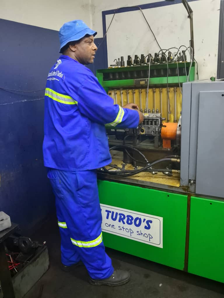 Workshop technician operating machinery