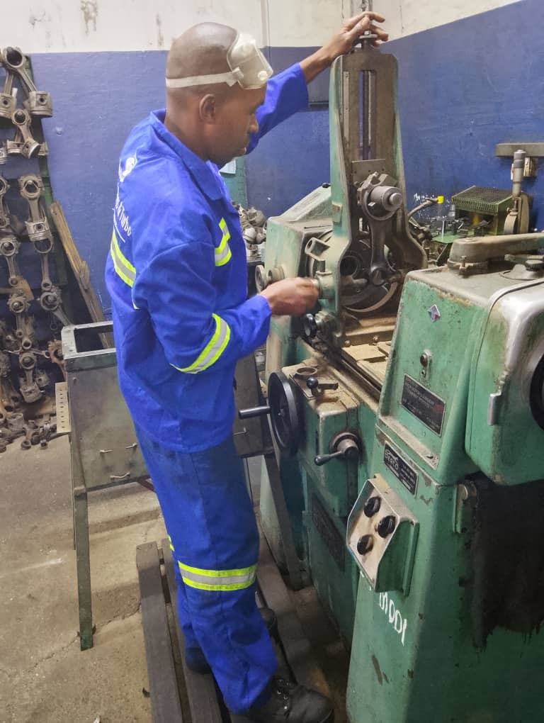 Workshop artisan at machinery